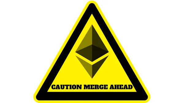 Yellow and black warning sign with Ethereum logo in the centre and the words "caution merge ahead".